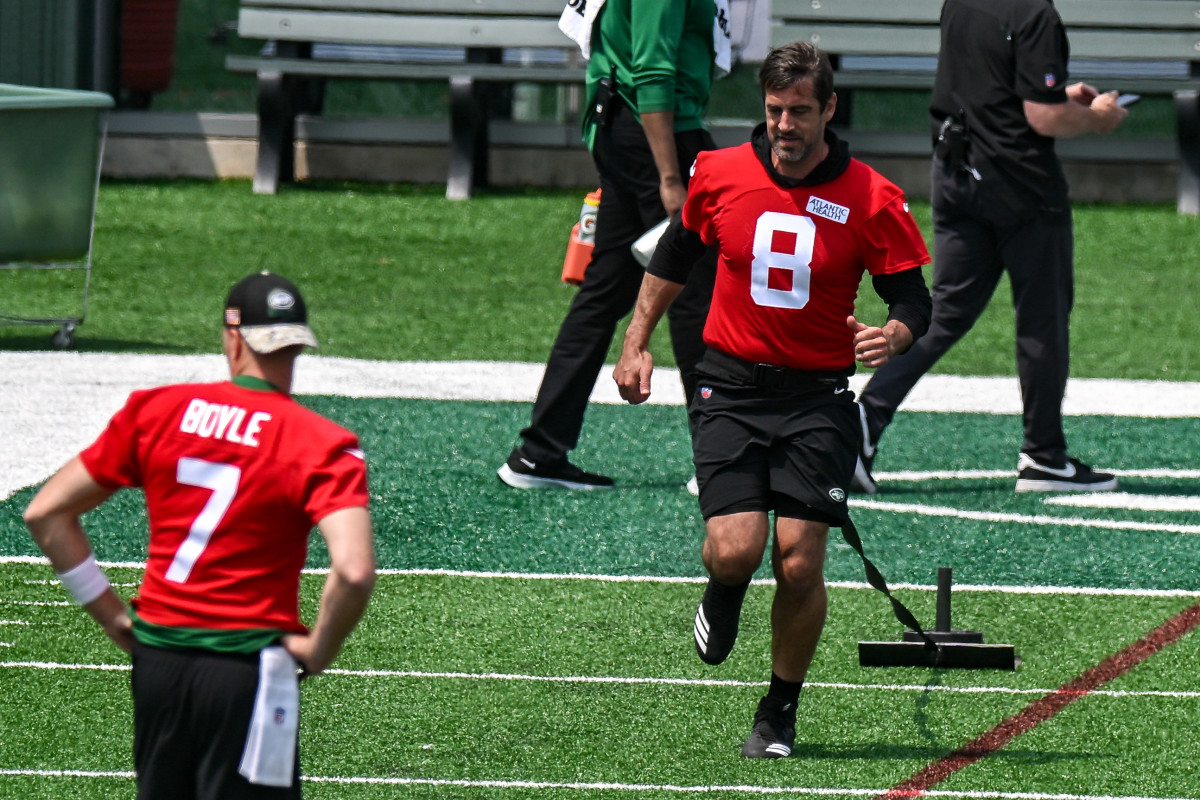 QB Aaron Rodgers pulls a weight during warmups on May 23